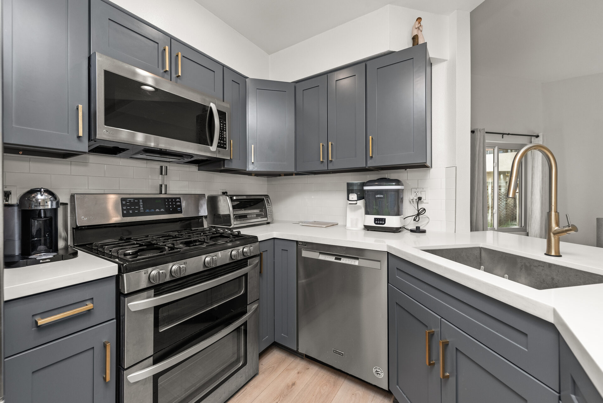 Kitchen wide with stove and cabinetry